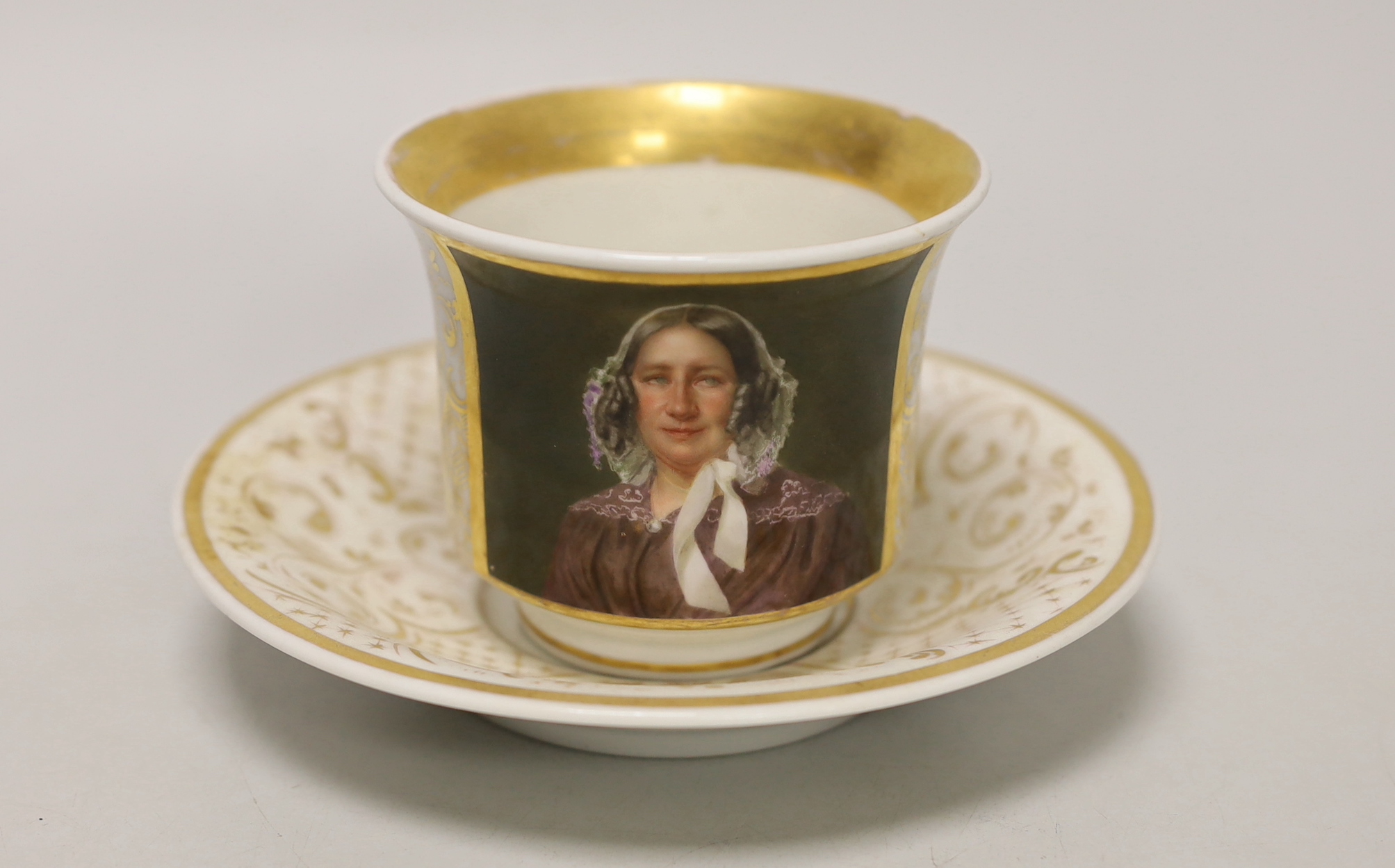 A Berlin KPM porcelain portrait painted cabinet cup and saucer, c.1847-9, 8.5cm high